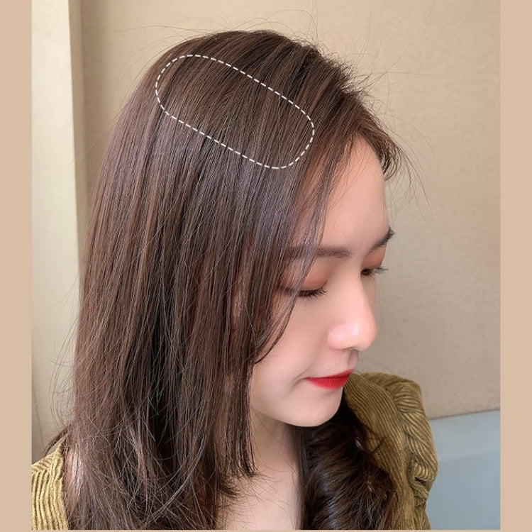 Burgundy sponge hairpin clipped on top of hair for extra height