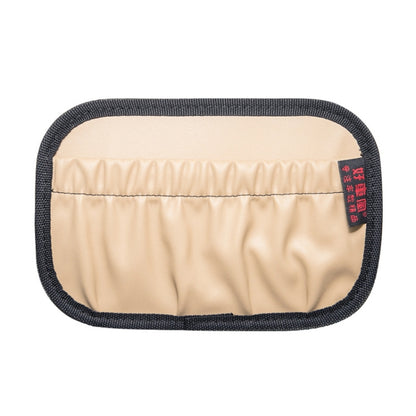 Beige car console hanging storage pocket with dark trim, quilted front panel.