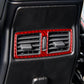 Dashboard rear air vent with red carbon-fiber trim sticker framing the louvers