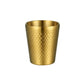 Gold hammered metal tea mug with vertical dot pattern, round rim, no handle