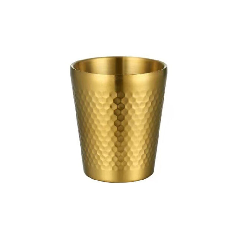 Gold hammered metal tea mug with vertical dot pattern, round rim, no handle