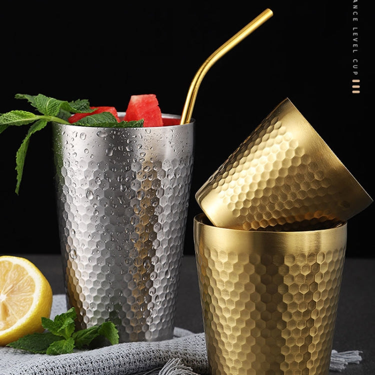 Stainless steel hammered mugs in silver and gold with drink and straw