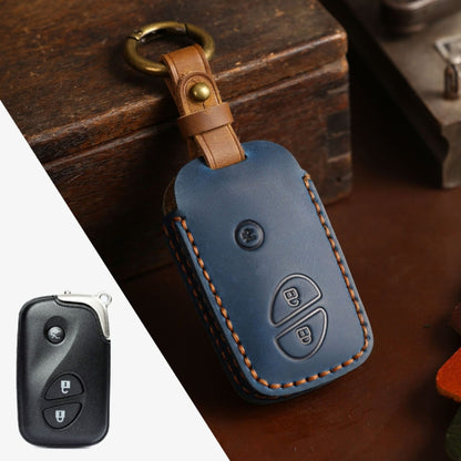 Blue leather key fob cover with brown keyring loop, contrast stitching, and button cutouts
