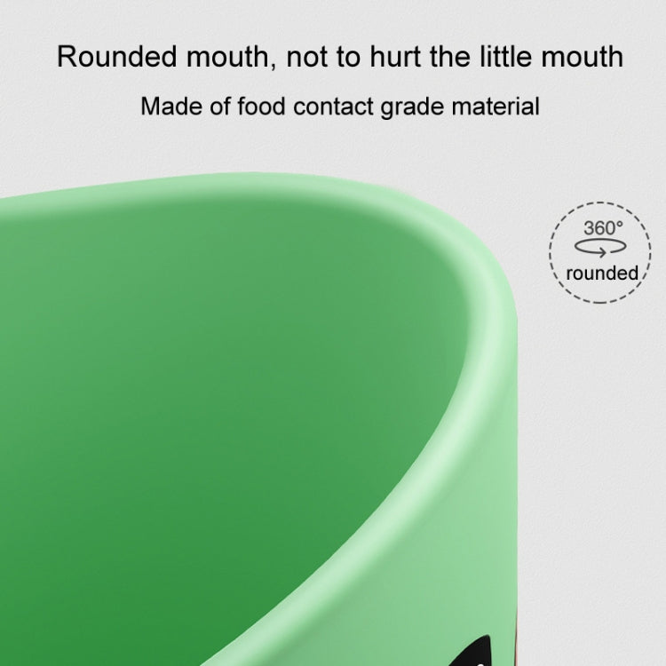 Close-up of green rounded rim on a baby dinosaur cup