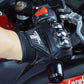 Black riding gloves with padded knuckle guards and logo patch on palm