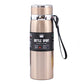 Beige vacuum insulated stainless steel mug with metal lid and black wrist strap