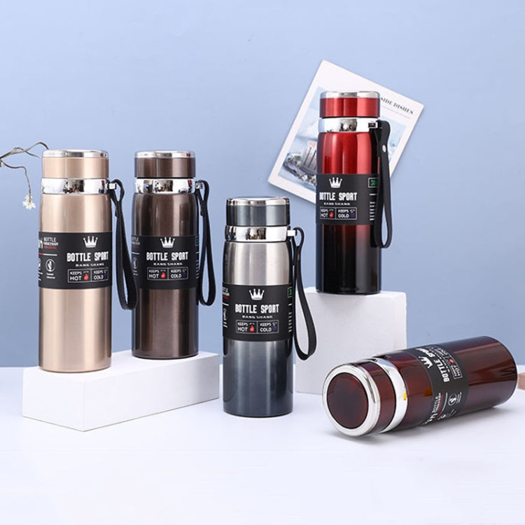Assorted vacuum insulated stainless steel mugs on display with metal lids and wrist straps