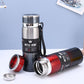 Black vacuum insulated mug with red lid details and open cap, plus matching red bottle