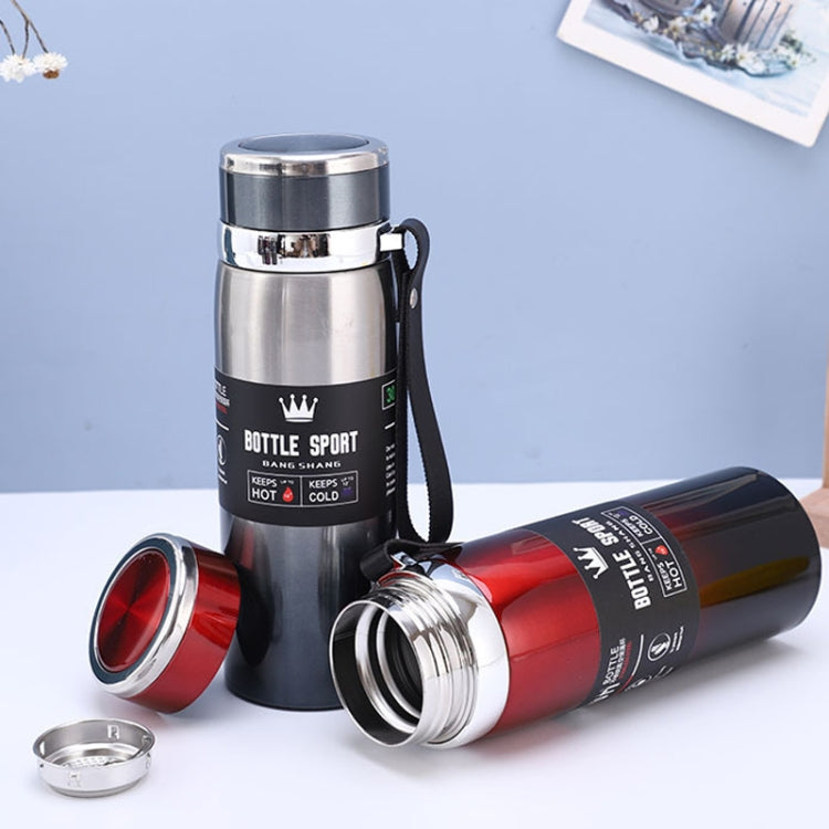 Black vacuum insulated mug with red lid details and open cap, plus matching red bottle