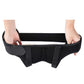 Adult hernia belt worn on a person, hands adjusting the black support straps