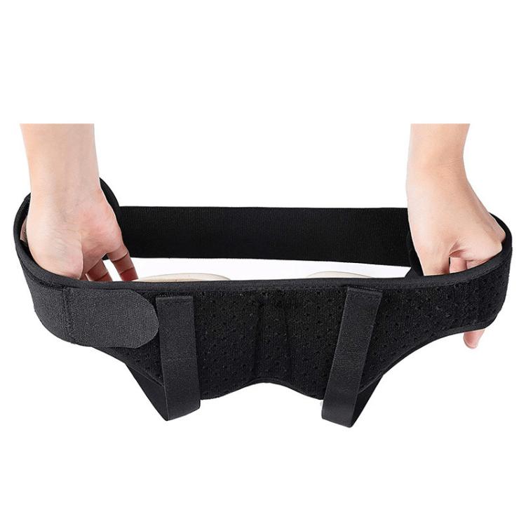 Adult hernia belt worn on a person, hands adjusting the black support straps