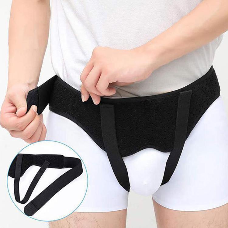 Adult groin support belt with hook-and-loop strap detail, black fabric, on waist
