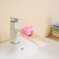 Pink deer-shaped faucet extender diverter with playful spout splash guard.