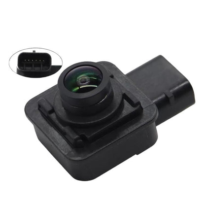 Black rear view backup camera module with green-tinted lens and mounting base