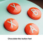 Wireless gaming controller buttons: four orange face buttons with white symbols