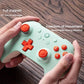 Wireless gaming controller held in hands: green shell with orange D-pad and buttons