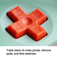 Wireless gaming controller D-pad close-up, orange cross on textured surface
