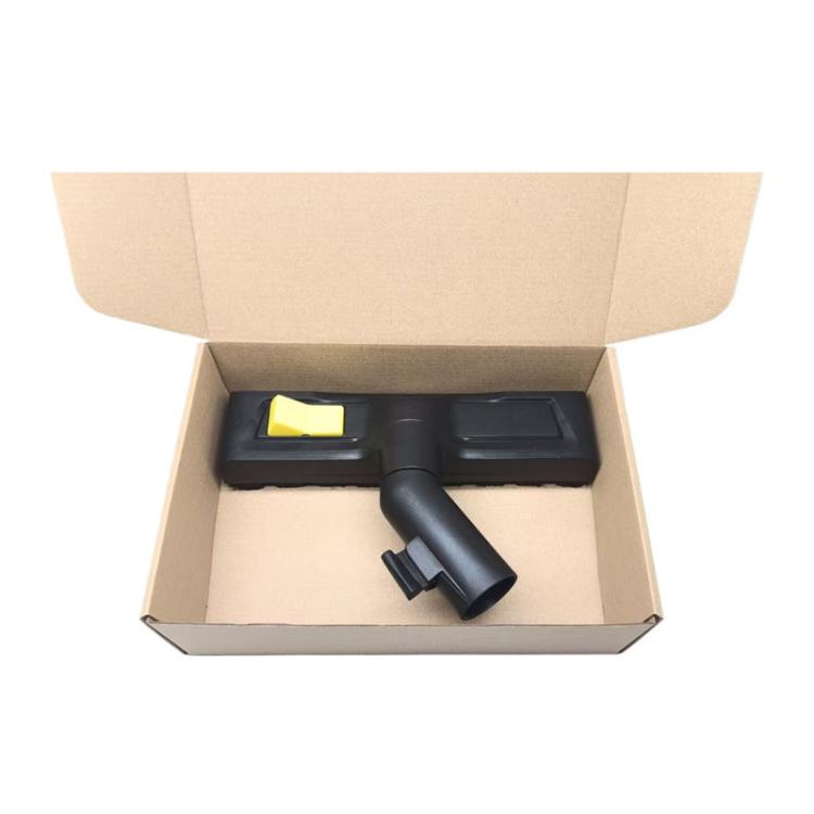 Floor cleaning brush attachment packed in box with yellow button visible