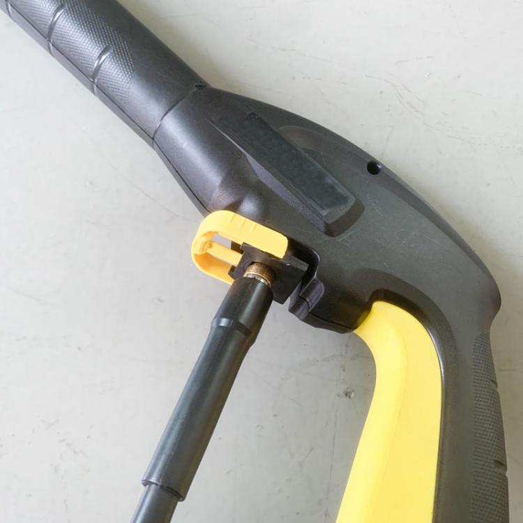 Yellow C-shaped sealing ring seated on a gray pressure washer coupling