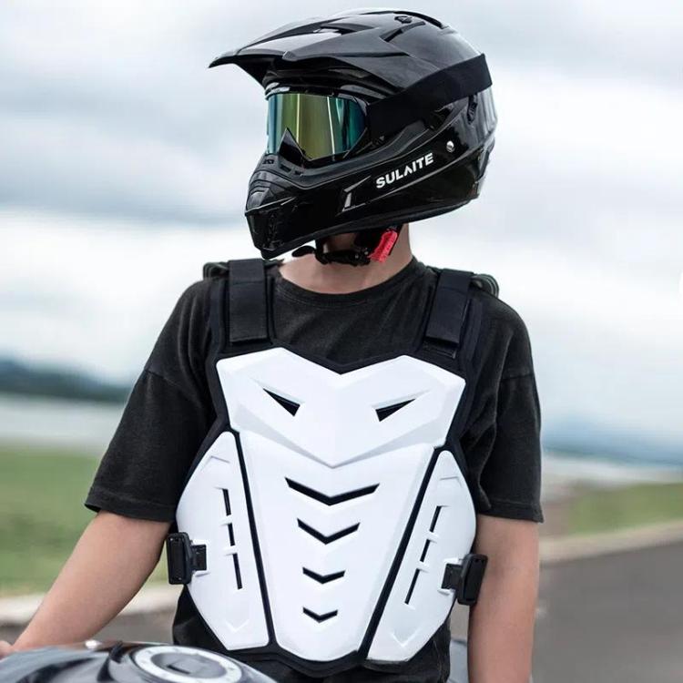 Black motocross rider wearing a white chest armor vest with shoulder straps