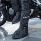 Black motorcycle rain shoe covers worn over jeans, splash-resistant and grippy sole
