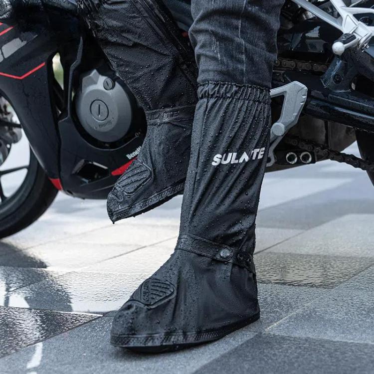 Black motorcycle rain shoe covers worn over jeans, splash-resistant and grippy sole