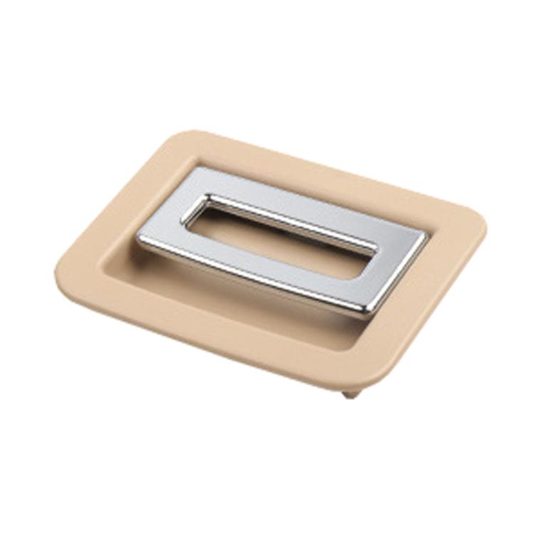 Beige plastic trunk puller/buckle insert with chrome metal center opening