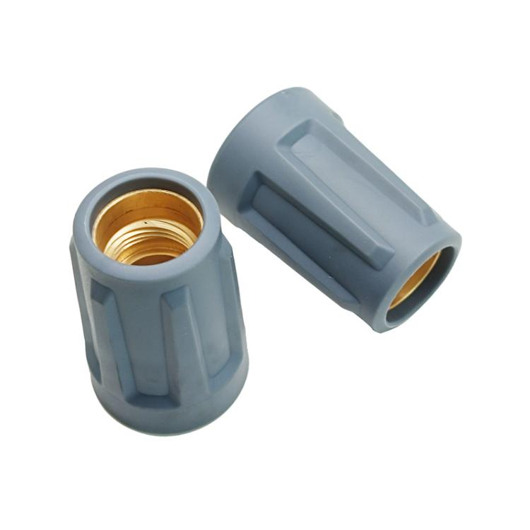 Nozzle cap with brass threaded insert and gray plastic body, angled view