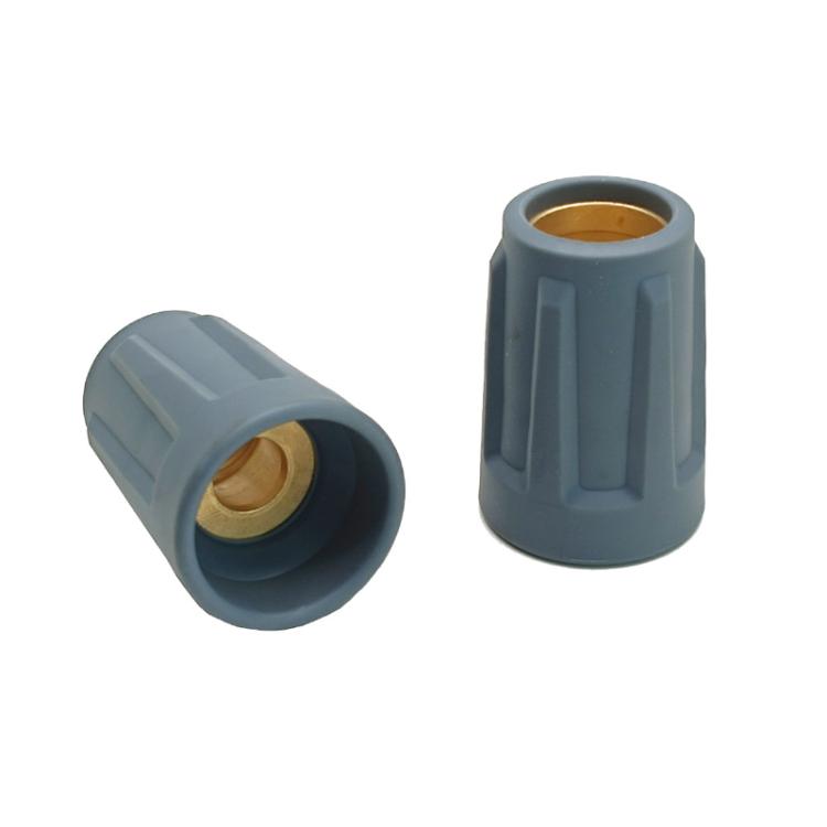 Pair of gray nozzle caps with brass inserts, one end-on and one side view