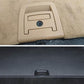 Beige trunk lid handle cover with lock hole mounted on car interior panel