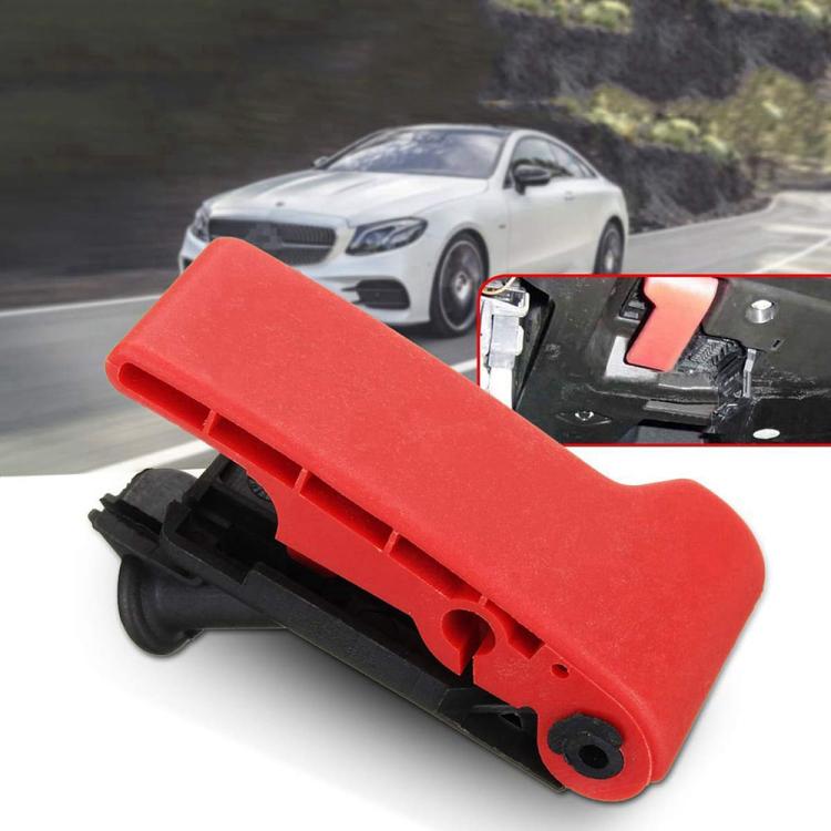 Red engine hood cover opener latch installed on vehicle engine bay cover