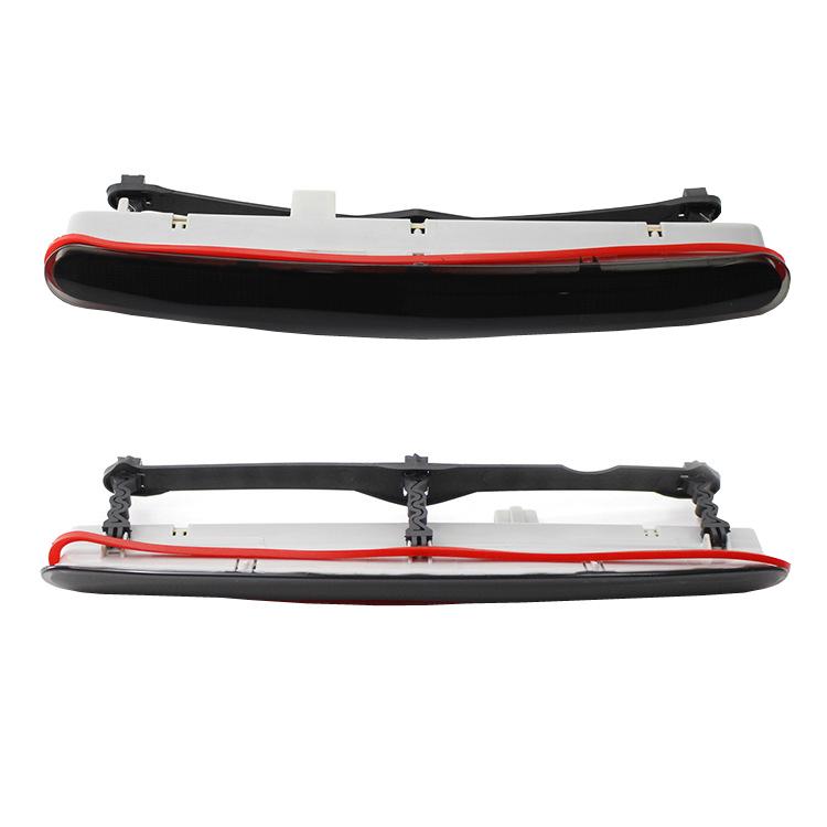 High mounted third brake light assembly with red strip lens and black outer housing