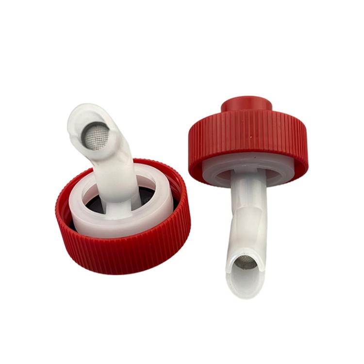 Water tank plug with red ribbed cap and white outlet fitting
