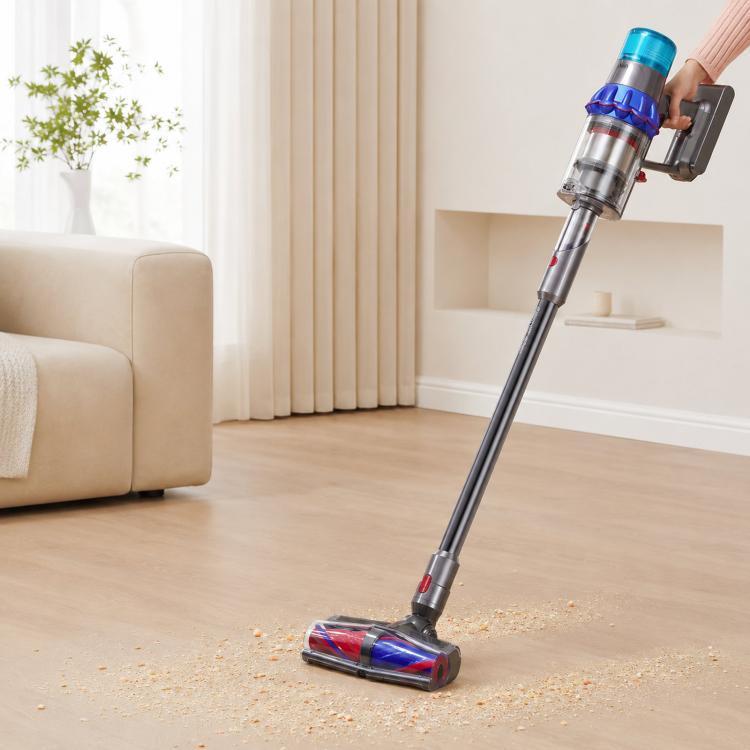 Vacuum floor brush attachment picking up debris on wood flooring