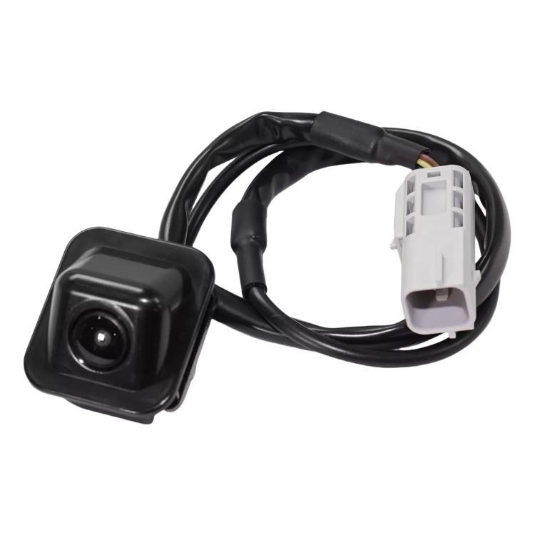 Reversing parking assist camera with black housing, lens, and white wiring connector
