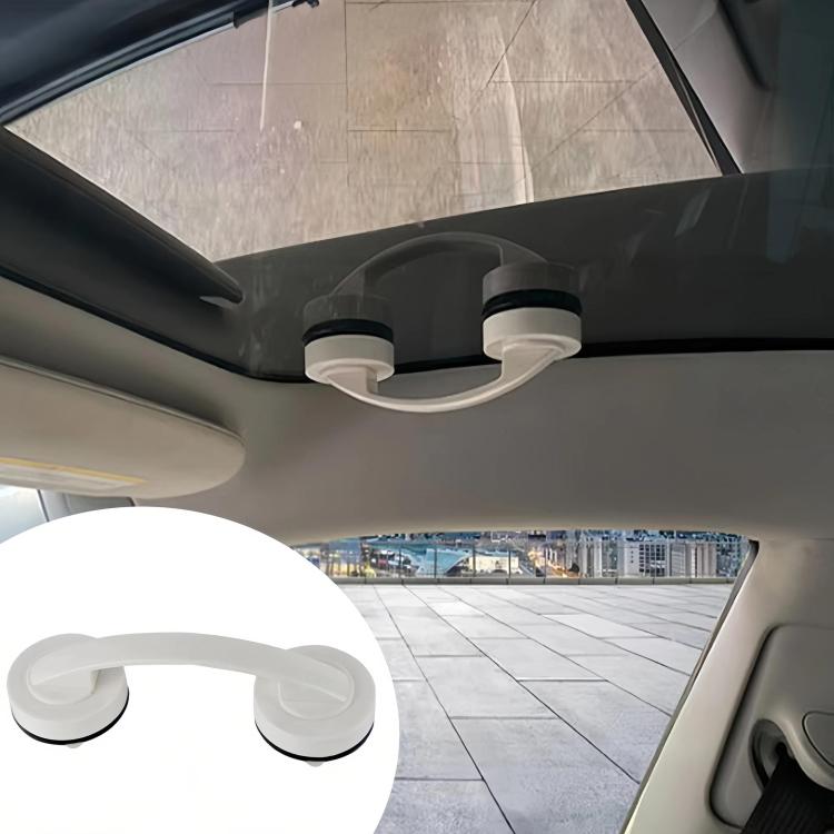 Two white suction cups connected by curved handle under car roof