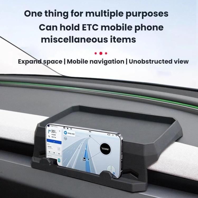 Gray dashboard tissue storage tray holding a smartphone on the dash