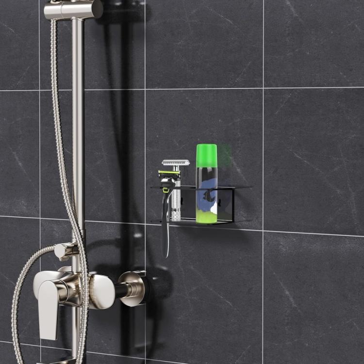 Wall-mounted black acrylic storage stand with razor slots in a bathroom