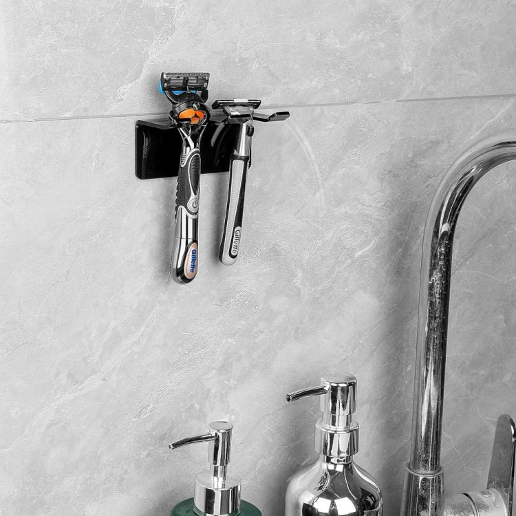 Self-adhesive razor storage holder holding multiple razors on a bathroom wall