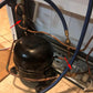 Copper pipe line with brass connector fitting installed on a compact appliance