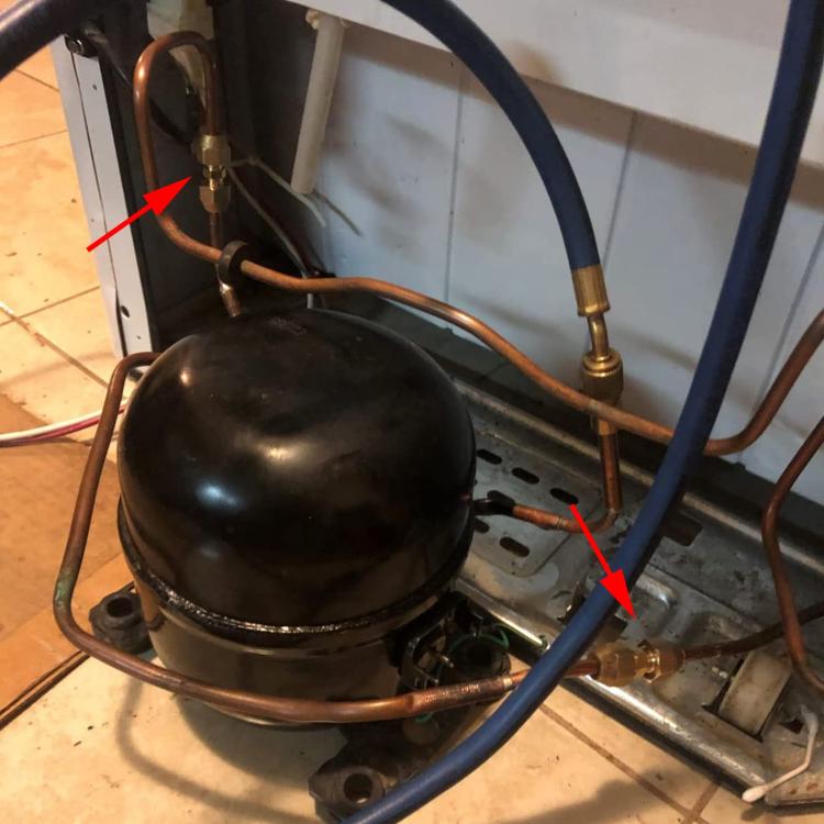 Copper pipe line with brass connector fitting installed on a compact appliance