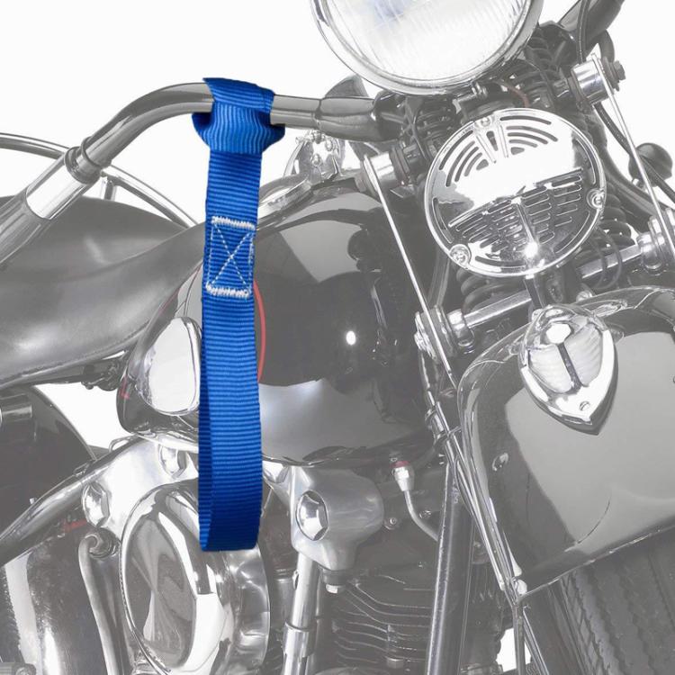 Blue cross-woven luggage strap secured to a motorcycle handle area