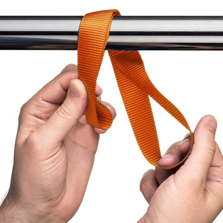 Orange cross-woven luggage strap looped and held in hands