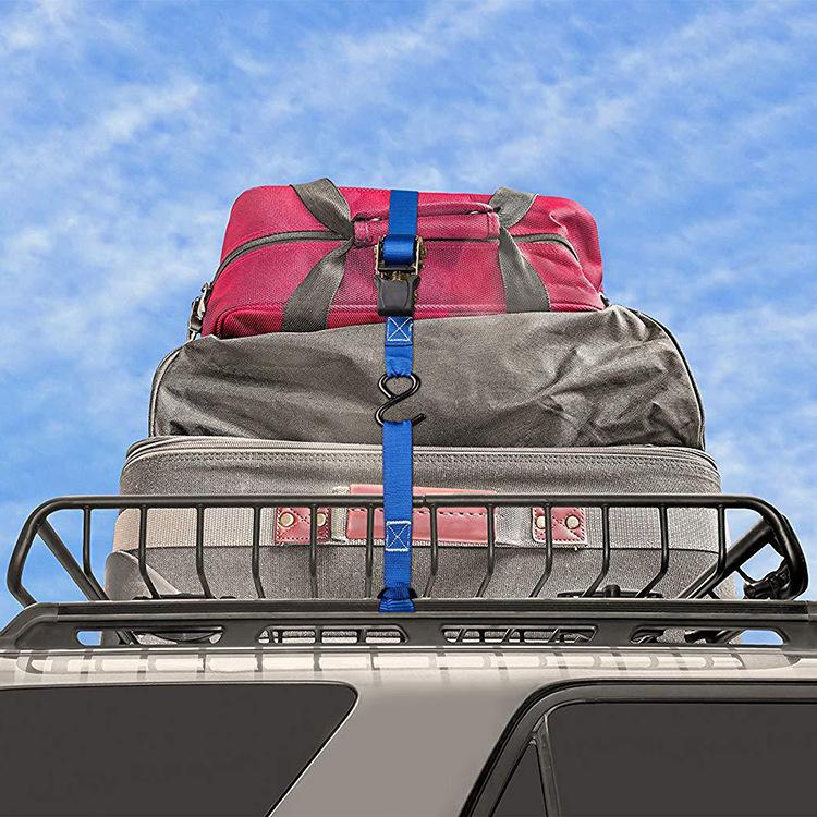 Blue cross-woven luggage strap fastening luggage on a motorcycle cargo rack