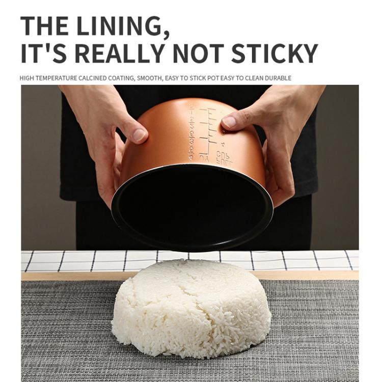 Car rice cooker with pot removed, showing nonstick inner surface and cooked rice