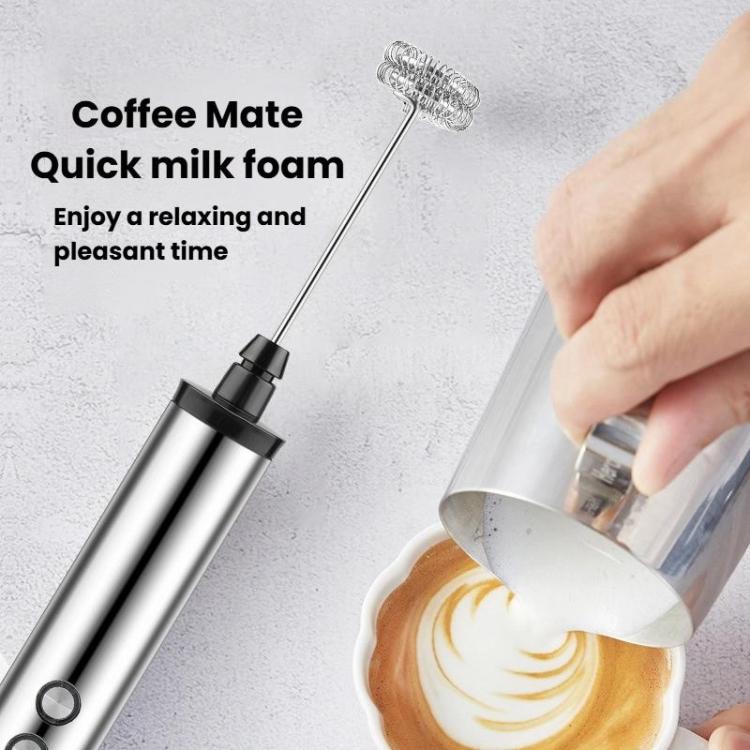 Handheld electric milk frother whisk head creating quick milk foam in a pitcher