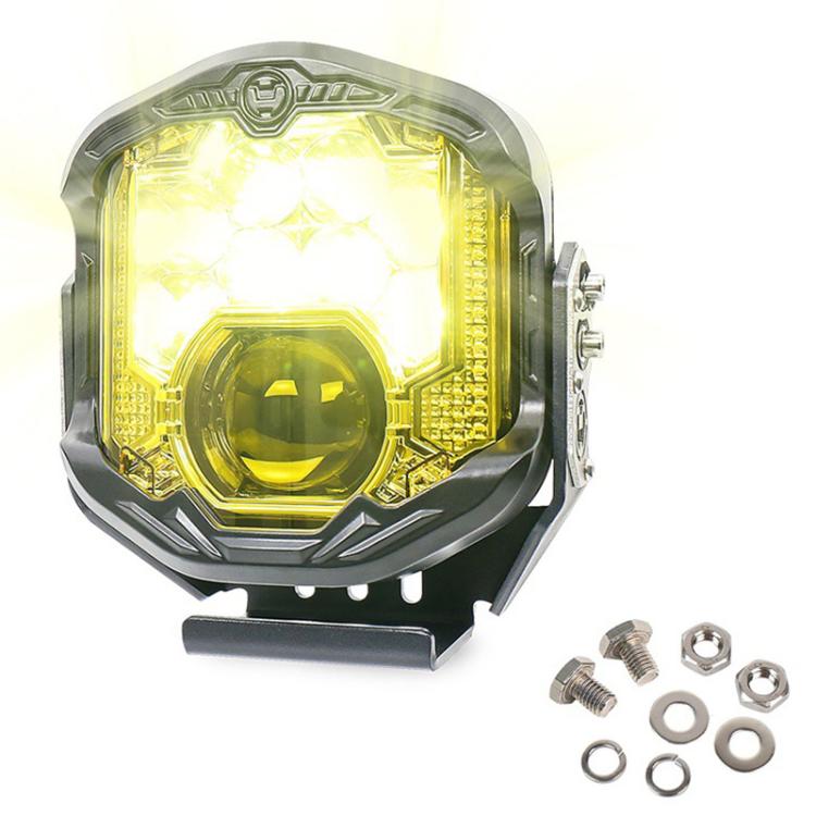 Illuminated LED work headlight with amber halo ring, black housing, mounting screws.