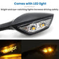 Close-up of black rearview mirror LED light with clear lens and glowing amber bulb