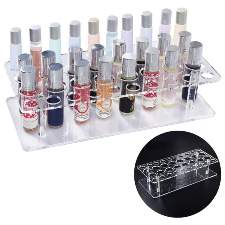 Clear acrylic lipstick storage stand with multiple lipsticks set upright in round holes.
