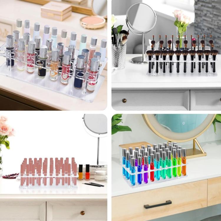 Transparent acrylic makeup organizer stand holding rows of lipstick tubes upright.
